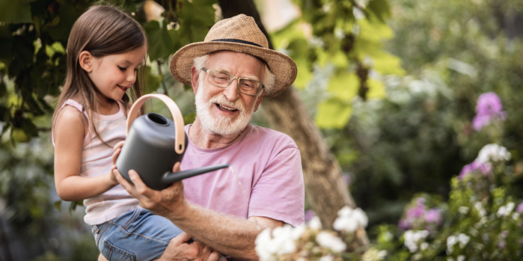 Grandfather gardening with his granddaughter