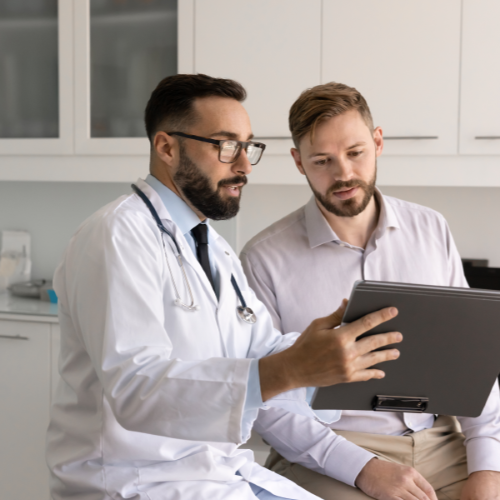 Doctor providing patient with patient education in an exam room