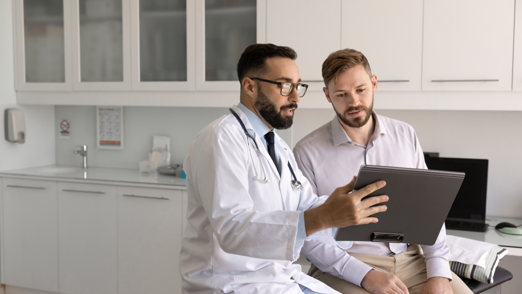 Doctor providing patient with patient education in an exam room
